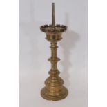 A heavy antique ecclesiastical brass pricket candlestick, with castellated cradle over a bladed stem