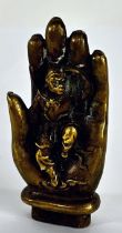 A Chinese brass Buddhism Brass Sun Wukong Monkey King upon a Buddha hand, 11cm