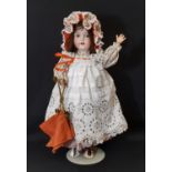 An early 20th century bisque head doll by Armand Marseille with jointed composition body, closing