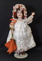 An early 20th century bisque head doll by Armand Marseille with jointed composition body, closing