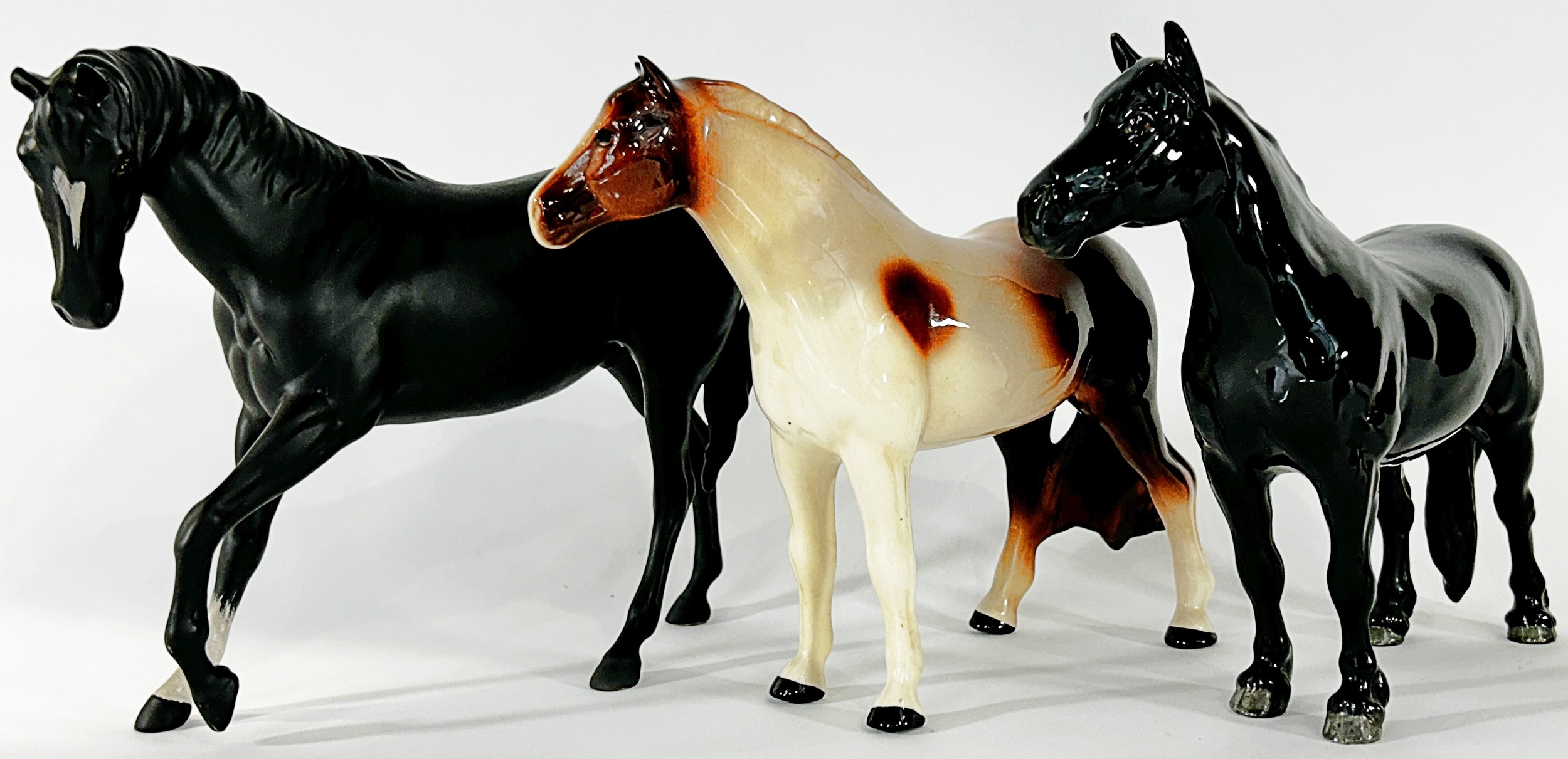 A Beswick black beauty, a fox, a recumbent sow and piglet and two further horses (5)