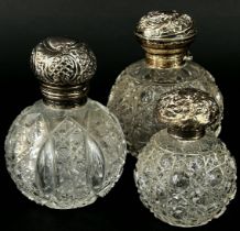 Three 19th century cut glass perfume bottles all with silver caps
