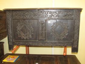 An 18th century oak coffer, the front elevation enclosed by two panels, with later geometric detail,