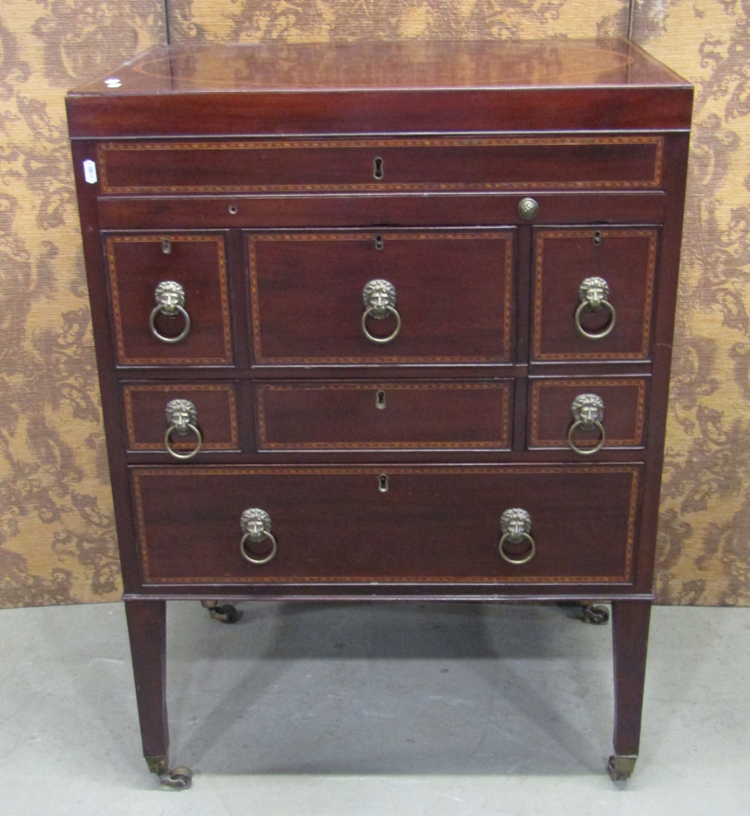 A Georgian mahogany gentleman's wash stand with rising lid, with comprehensively fitted interior,