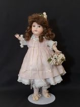 An early 20th century bisque head doll by Armand Marseille with jointed composition body, closing