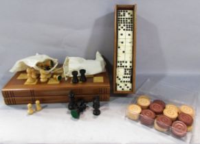 An Antique Nine Dot Domino set in a wooden case, only 53 tiles, a set of wooden draughts counters,