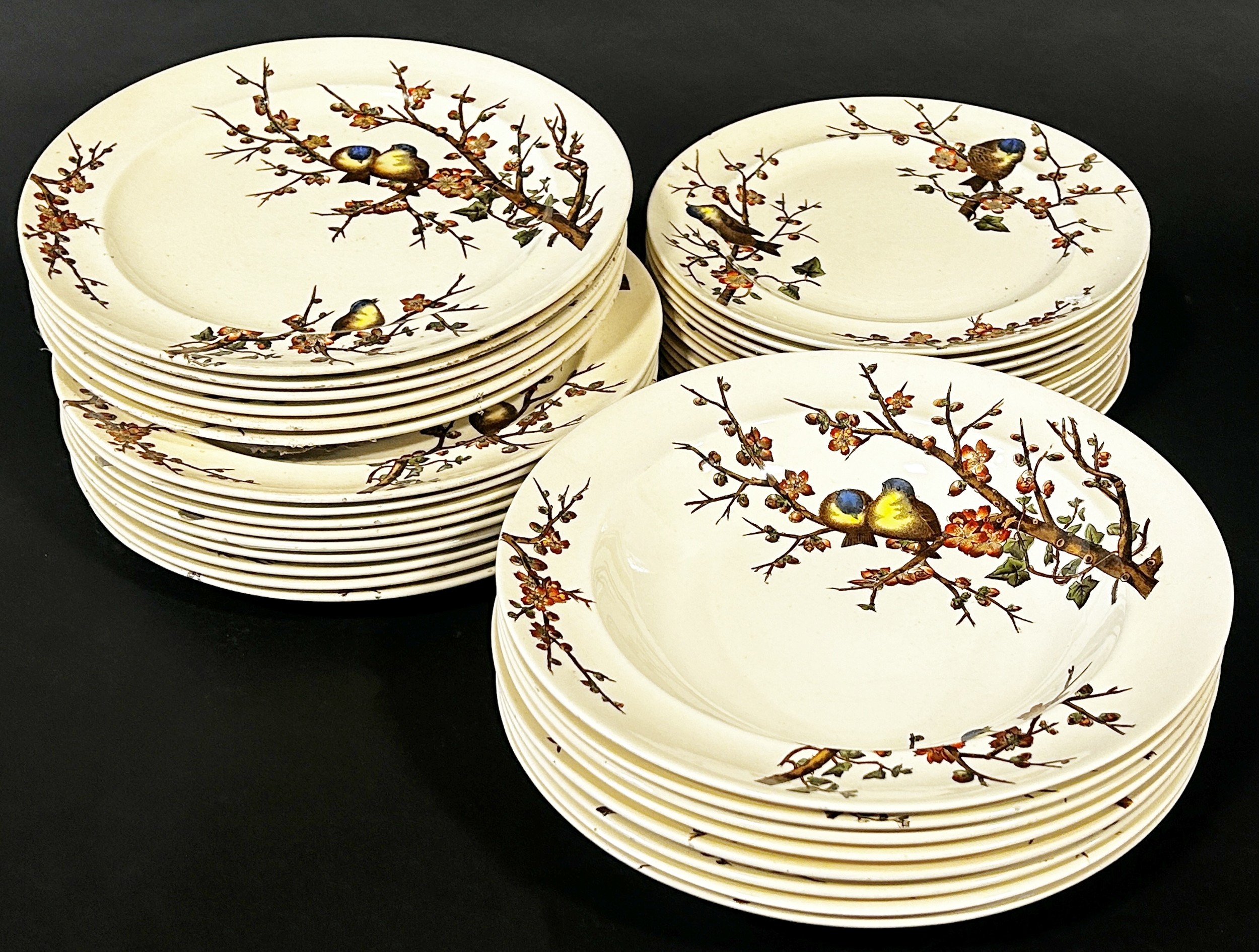 A Victorian dinner service by George Jones & Sons Almonds pattern showing finches amongst