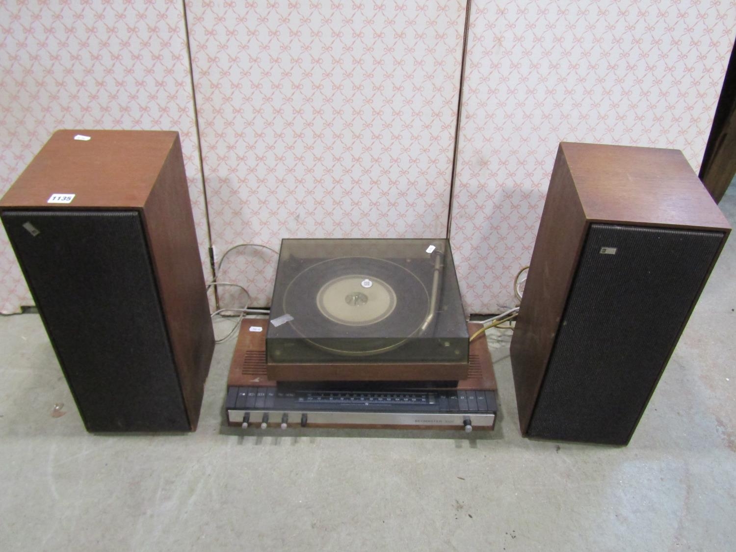 A vintage Bang & Olufsen audio set comprising Beomaster 1000, a 1000 Beogram record deck, and a pair