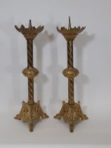 A pair of continental ecclesiastical brass pricket candlesticks with acanthus cradles over knopped