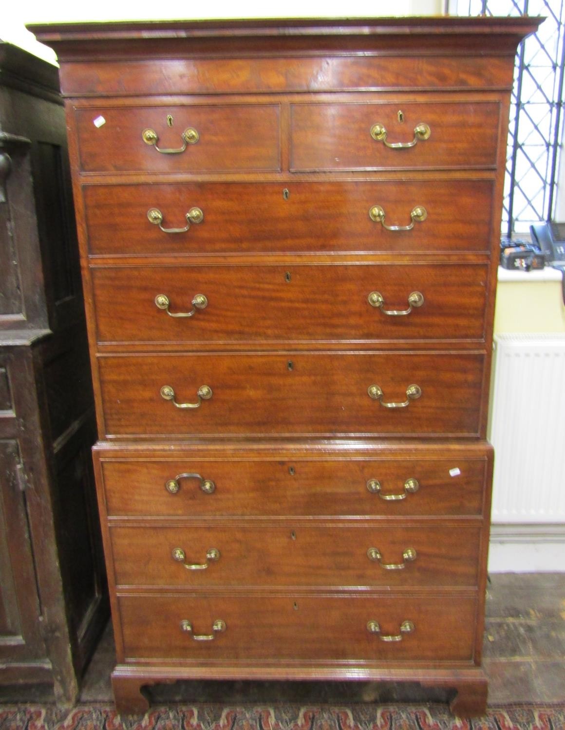 A Georgian mahogany chest on chest fitted with an arrangement of six long and two short drawers on