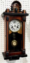 A small German wall clock with applied ebonised borders and mounts, 52 x 22cm