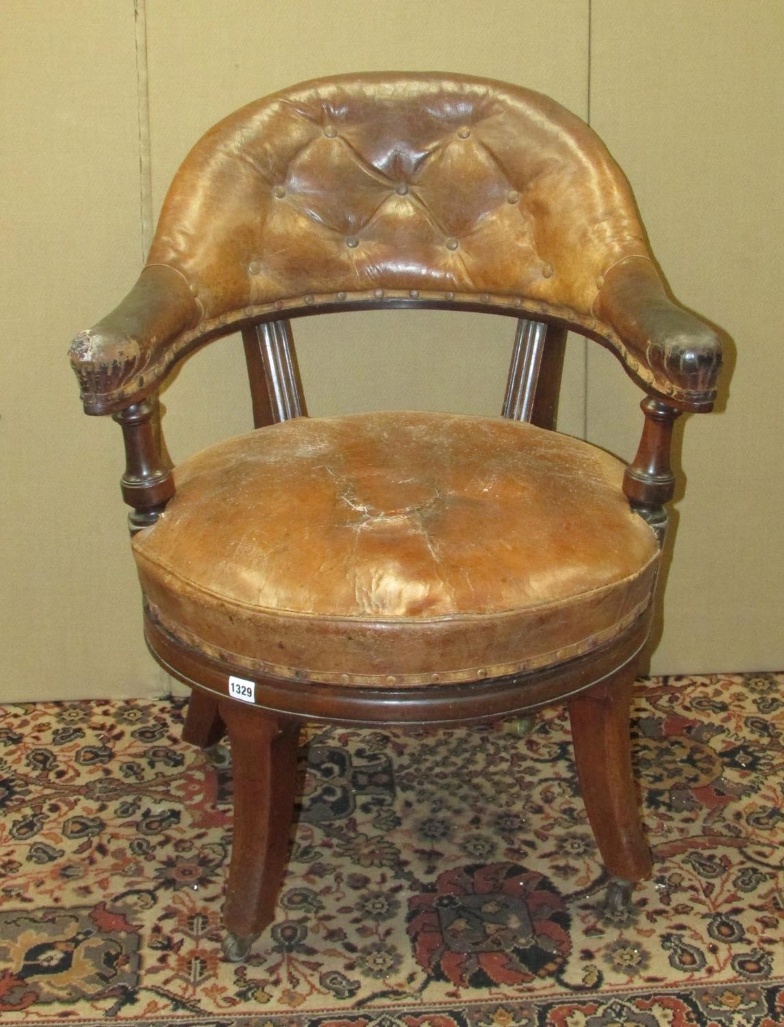 A 19th century library chair by Holland & Sons (stamped twice to legs) with revolving seat with