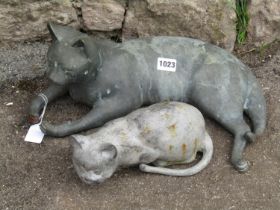 Two cast metal reclining cats