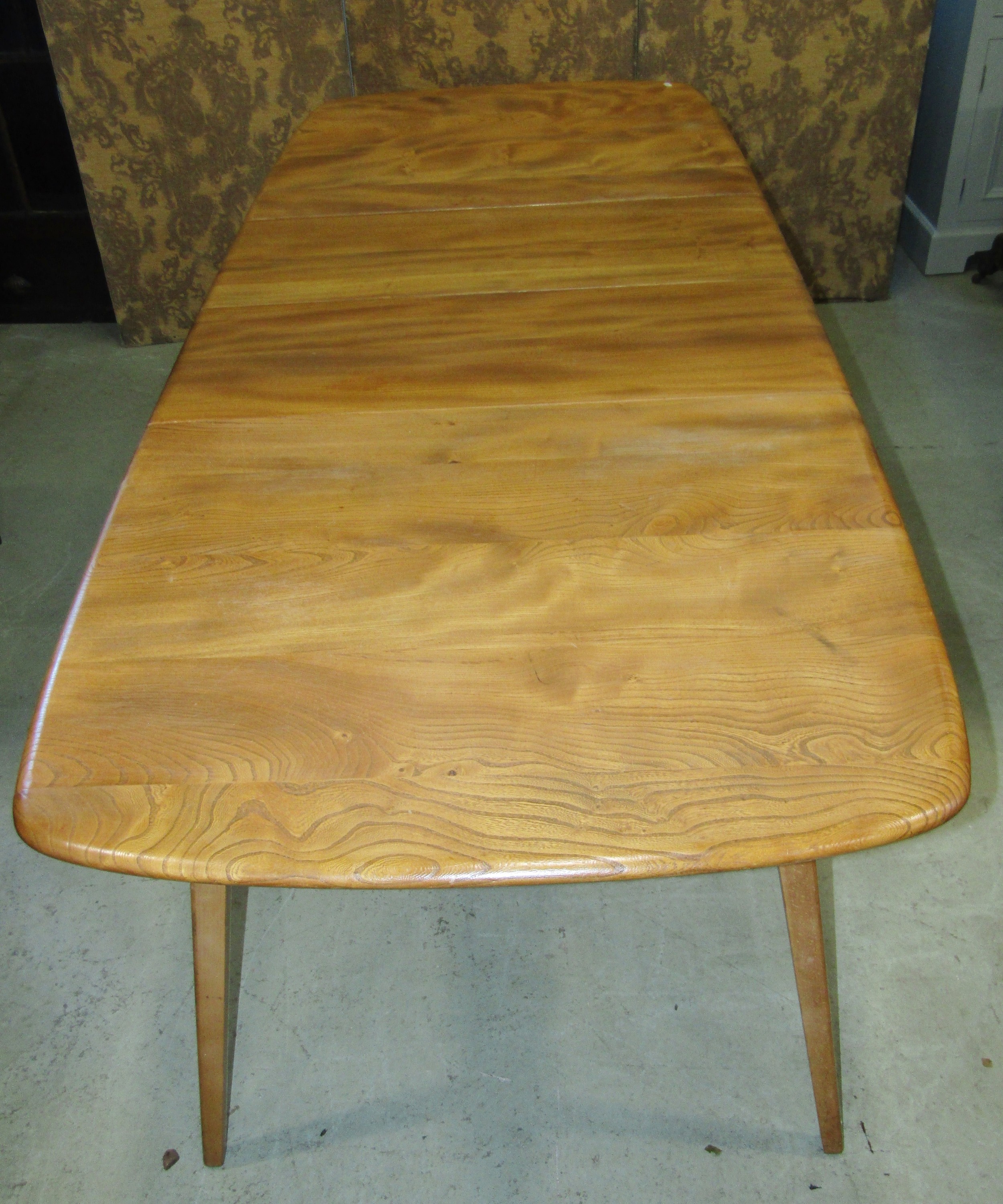 An Ercol extending dining table with additional folding leaf, elm table on square cut splayed - Image 2 of 6