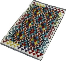 A small Chobi kilim mat with two rows of zig-zag connecting medallions, 87 x 55cm approximately