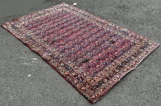 An old Doroskh rug with a tight Paisley design in blue and red tones, 222cm x 140cm