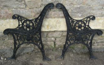 A pair of cast iron bench ends with decorative finish