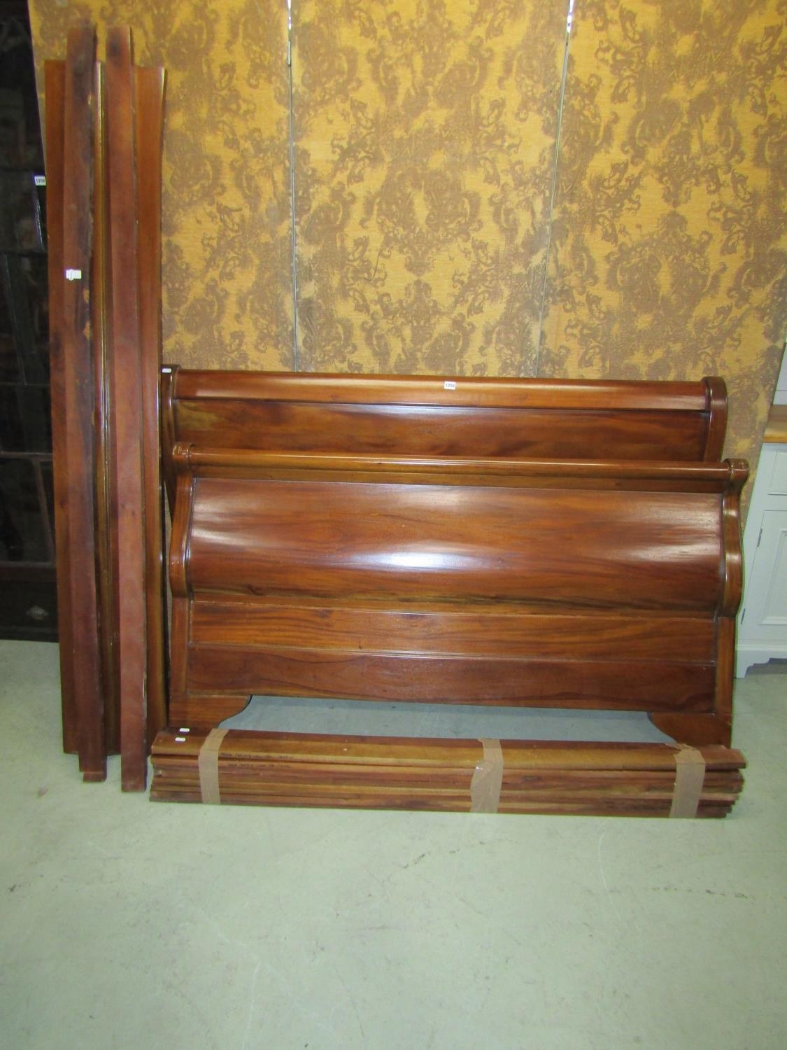 A mahogany sleigh bed frame of usual form to accept a 5ft mattress