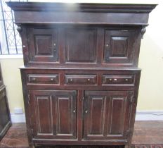 An 18th century oak Dudarn, the lowers section enclosed by two panelled doors and three frieze