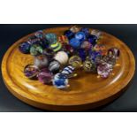 A “House of Marbles” type 60 cm diameter wooden Solitaire Board with a complete set of marbles