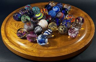 A “House of Marbles” type 60 cm diameter wooden Solitaire Board with a complete set of marbles