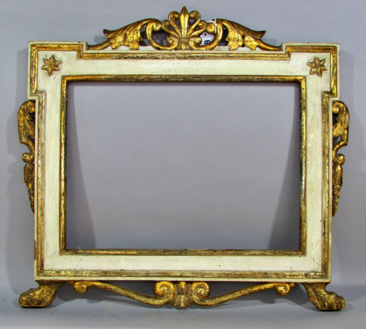 A 19th century continental carved and painted wooden frame, with pierced scrolling surmount, and
