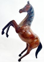 A vintage leather rearing horse, 85cm high. (Some repairs)