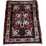 A small Iranian Hosseinabad rug with a central petal medallion 90cm x 63cm approximately