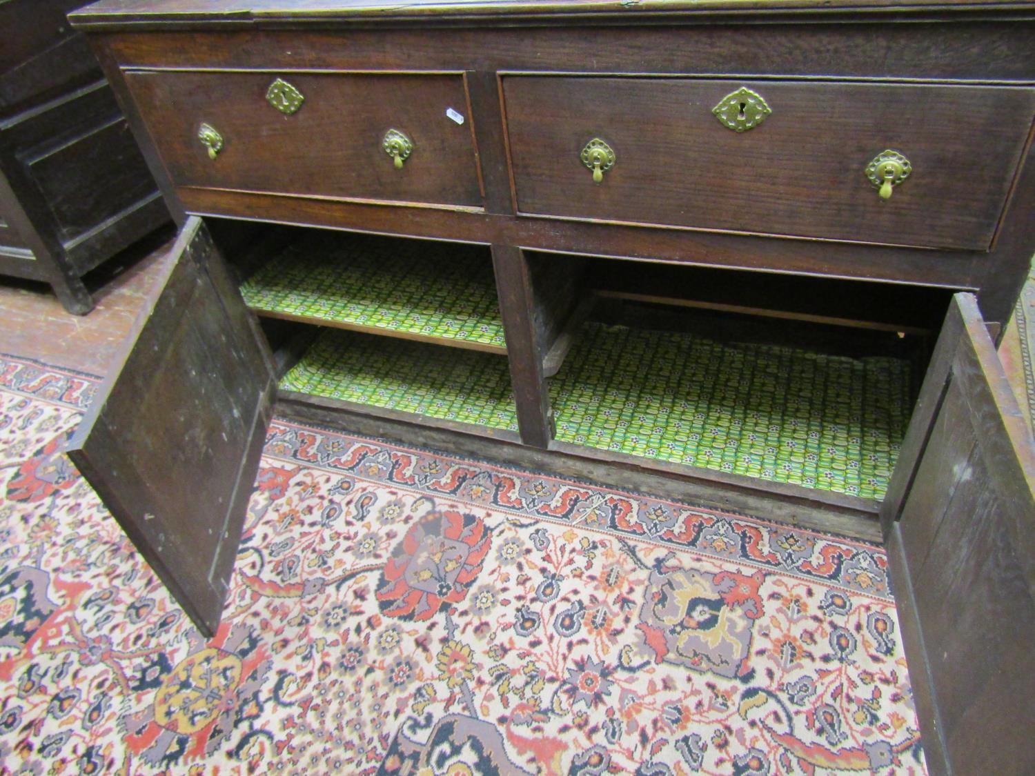 A Georgian oak dresser base with two frieze drawers and two panelled doors, with iron butterfly - Image 3 of 3