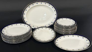 An Alfred Meakin Bleu de Roi dinner service with repeating floral detail within a blue and gilt band
