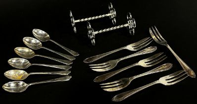 A cased set of six silver cake forks, a cased set of coffee spoons, a cased set of six teaspoons and