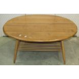 An Ercol occasional table principally in elm, the oval top 100cm max