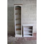 A tall narrow upright bookcase enclosing adjustable shelves within a painted and reeded framework