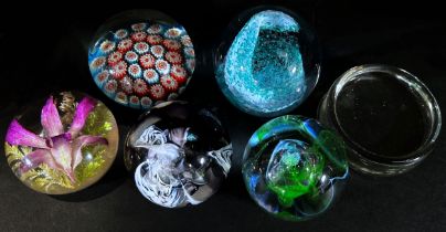 Six paperweights, flowers, Millefiori , swirls and bubbles etc and a single clear weight