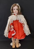 An early 20th century German bisque head doll by Max Oscar Arnold with jointed composition body,