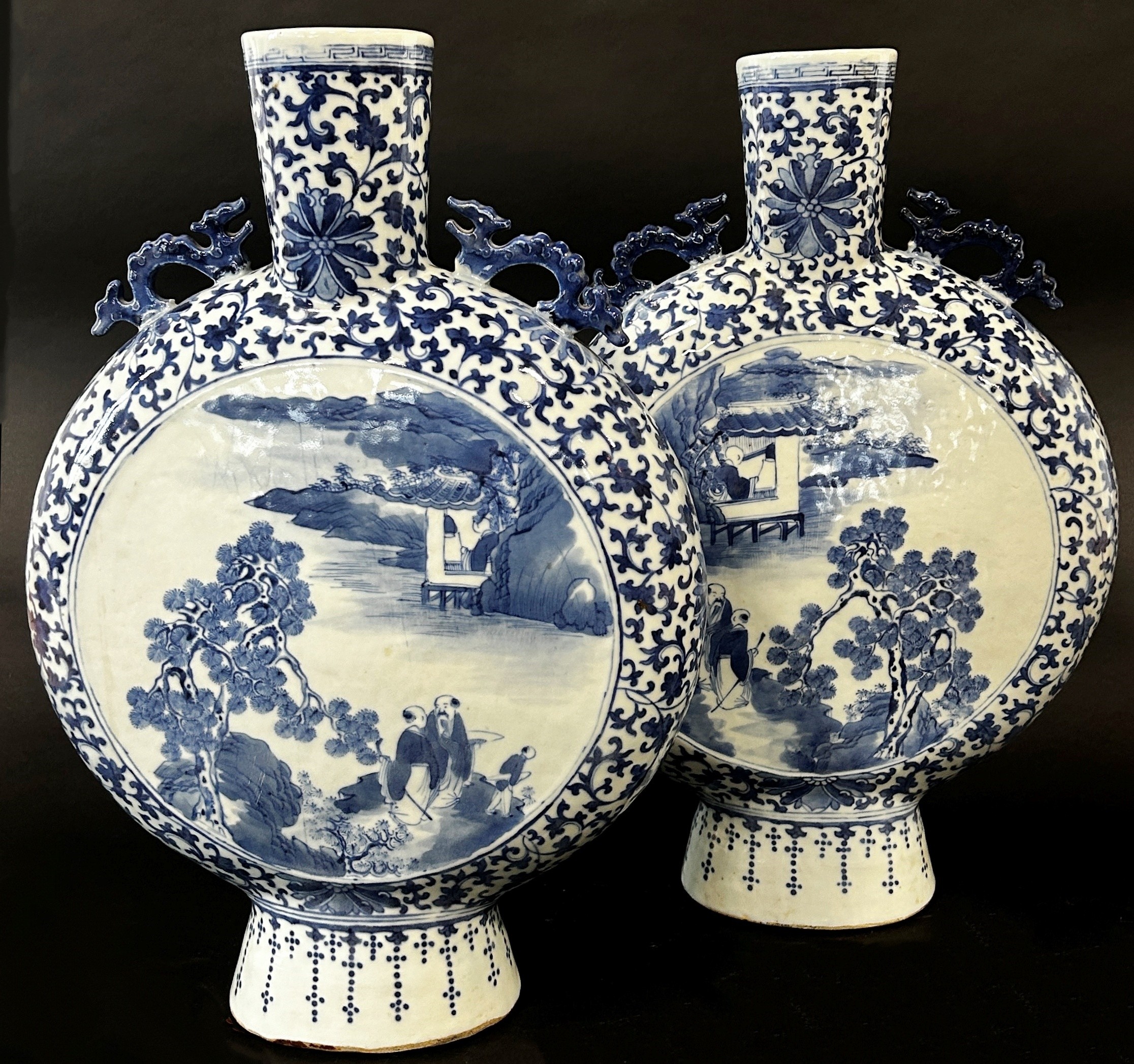 A pair of large blue and white Chinese moon flasks, Qing Dynasty showing characters in landscape