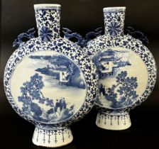 A pair of large blue and white Chinese moon flasks, Qing Dynasty showing characters in landscape