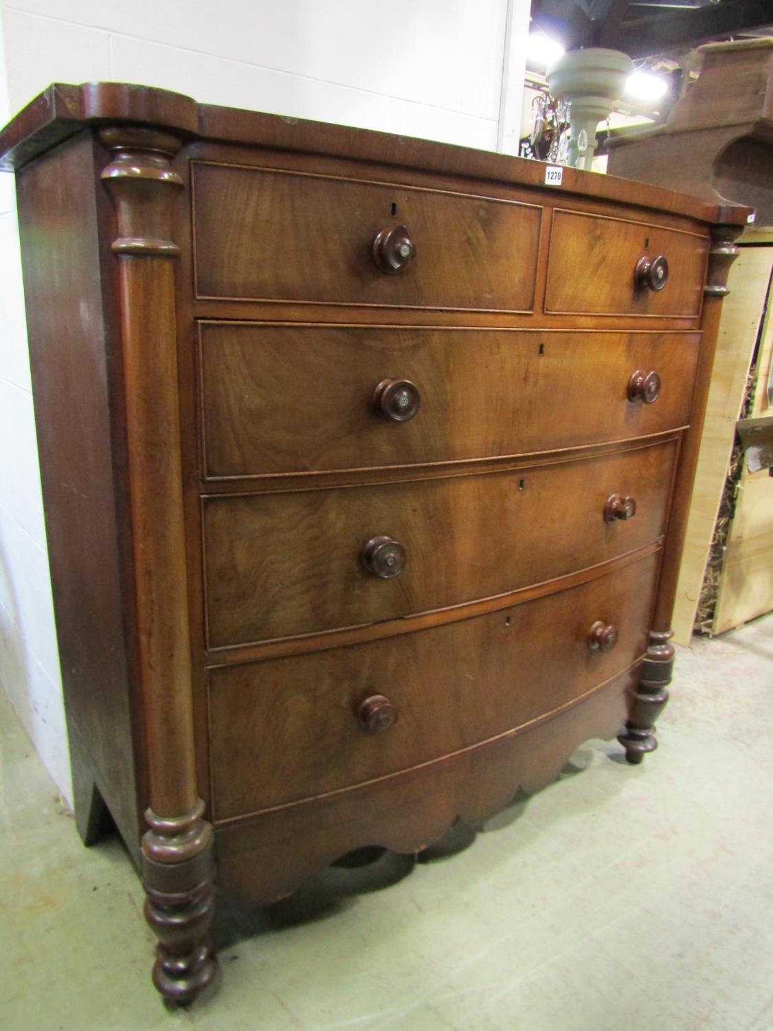 A Victorian mahogany bow front chest of three long and two short drawers with column supports, 128cm
