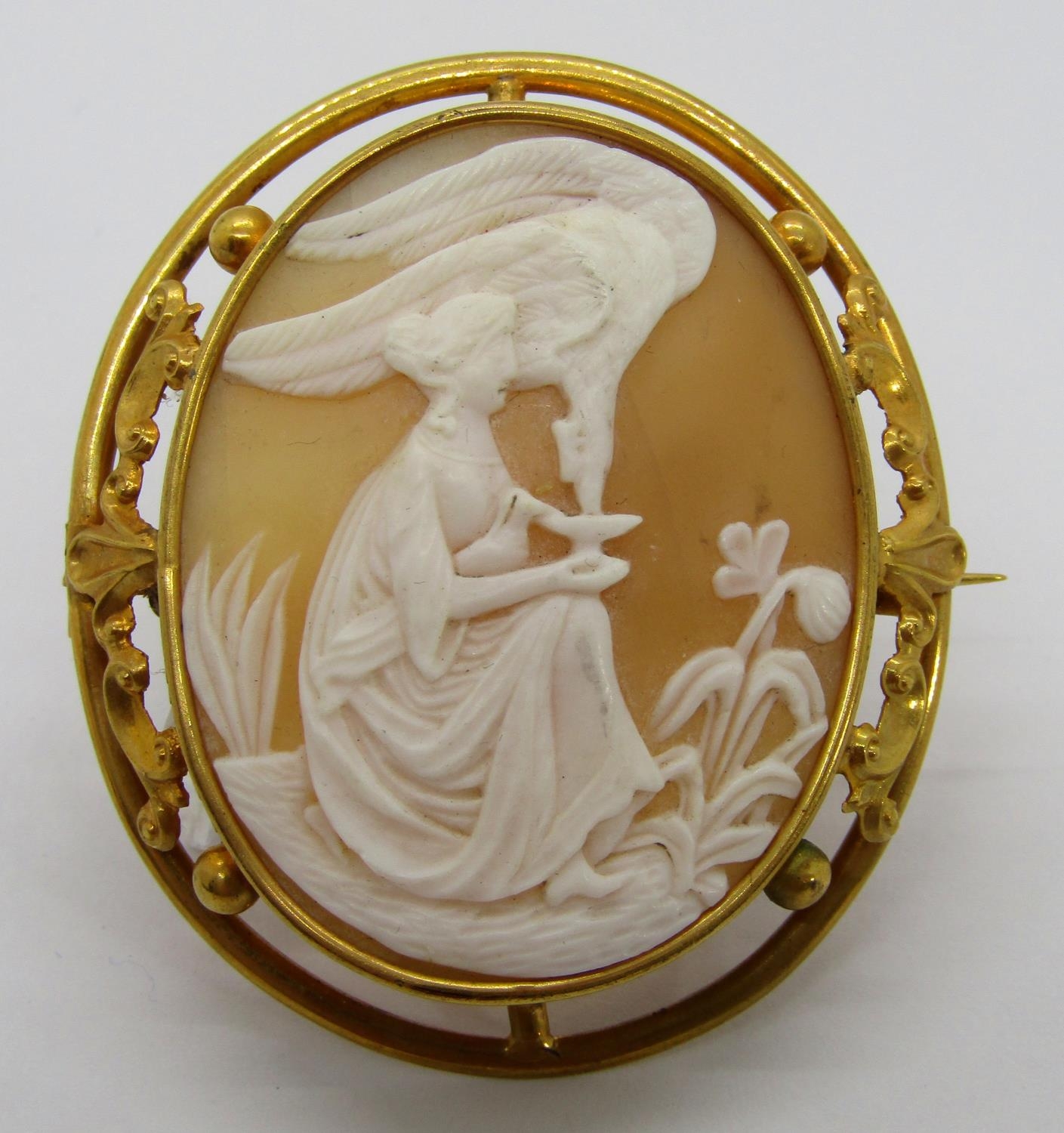 A large yellow metal framed cameo brooch, decorated with a classical narrative vignette, 5.5 x