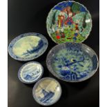 Four Delft plates, a Persian plate showing musicians upon a terrace, (5)