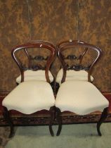 Set of four Victorian rosewood balloon back chairs with carved splats and cabriole supports