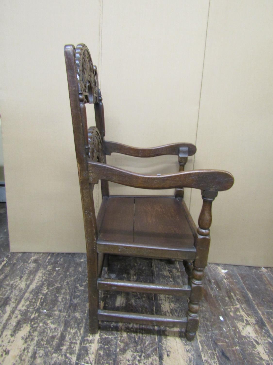 An antique oak South Yorkshire elbow chair of traditional form with carved and arched ladder back, - Image 3 of 4