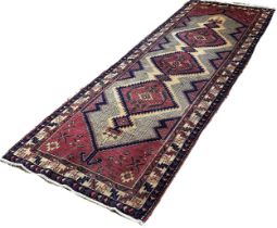 North West Persian Heriz Runner, with a row of three pink medallions with zig-zag surrounds, 307cm x