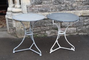 A matched pair of French steel cafe tables, circular tops on swept tripod bases, 61cm diameter