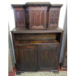 An old English style oak cupboard with linen fold panels, geometric and carved detail, 162cm high
