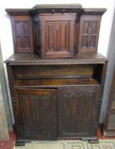 An old English style oak cupboard with linen fold panels, geometric and carved detail, 162cm high