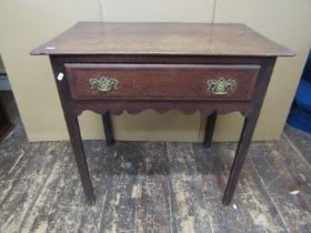 A Georgian oak country made side table with frieze drawer, crossbanded in walnut with shaped apron