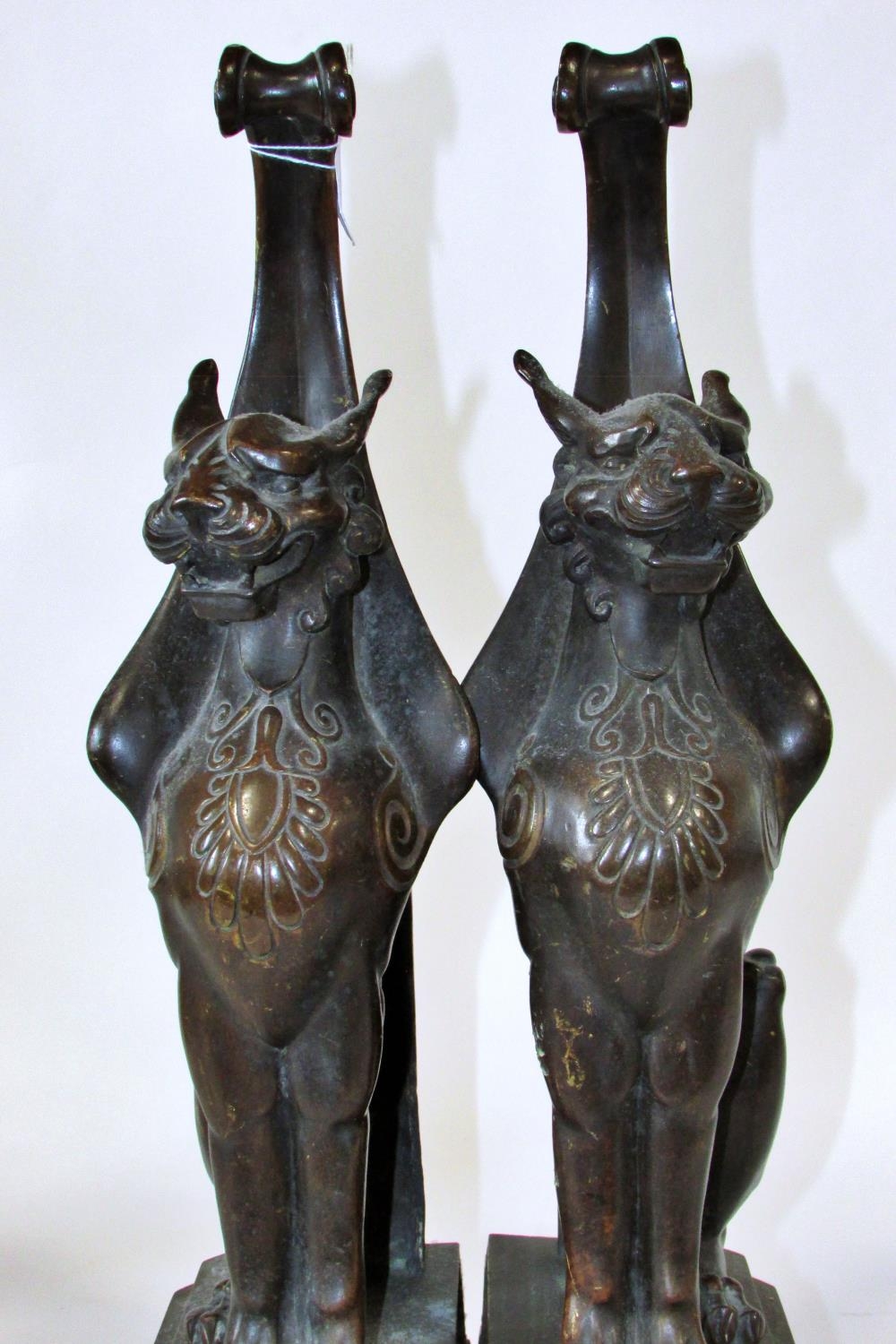 A substantial pair of 19th century cast bronze gryphons, seated in profile, raised on stepped - Image 6 of 6