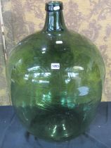 A large green hand blown glass carboy, 66cm high