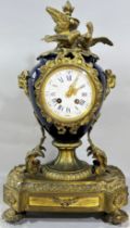 A 19th century gilt metal and porcelain mantle clock, the white enamelled dial with blue Roman and